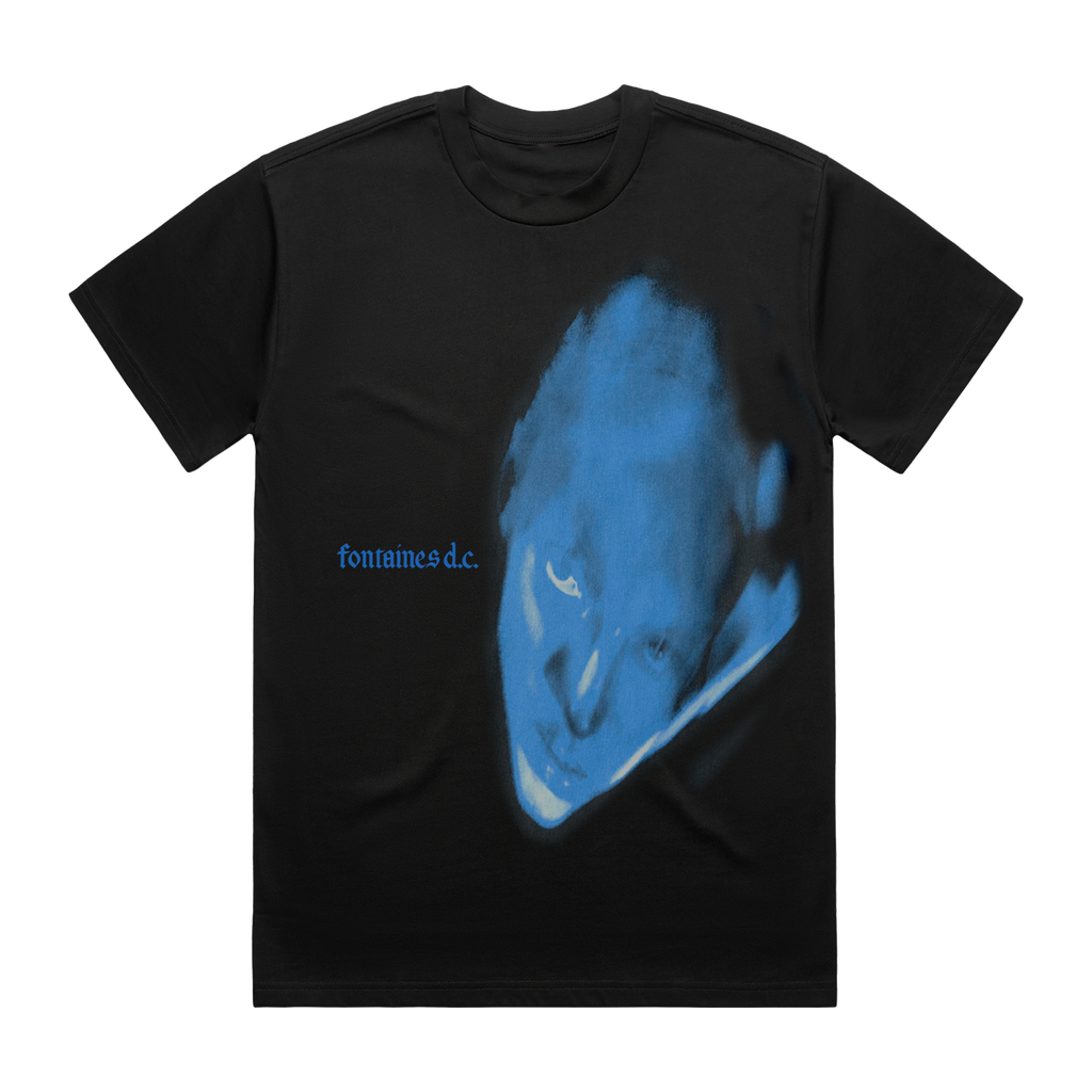 A black short-sleeve t-shirt featuring a large blue graphic print of a distorted face on the front, with the text 'fontaines d.c.'